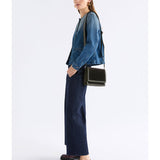 Dark olive ELK The Label Vel crossbody bag with adjustable strap and sleek design, shown with zipper closure and compact shape.