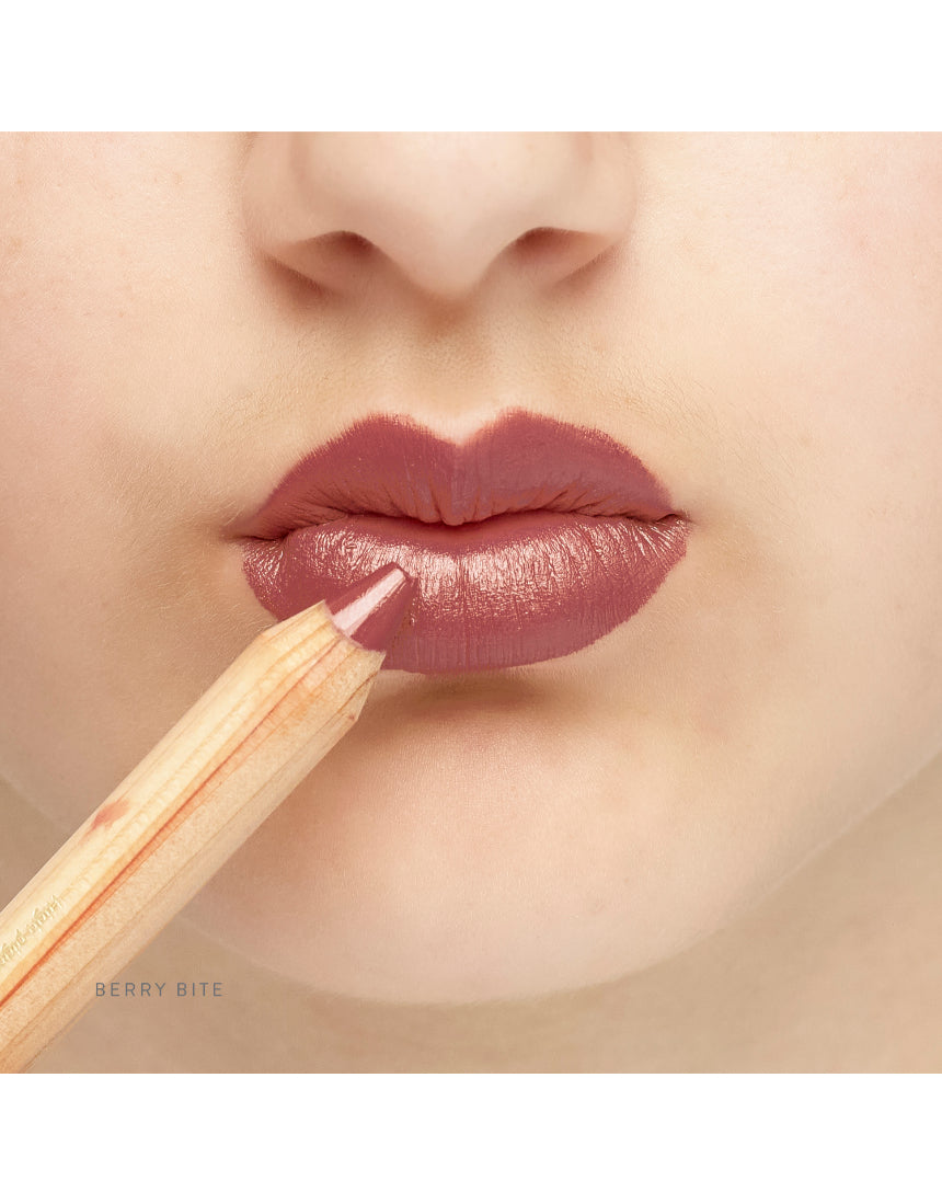 Lük Beautifood Natural Lipstick Crayon in Berry Bite applied on lips, showcasing rich berry color and smooth finish.