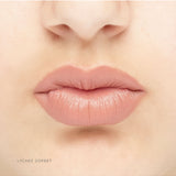 Luk Beautifood Natural Lipstick Crayon in Lychee Sorbet shade on lips, showcasing vibrant pink color and smooth application.