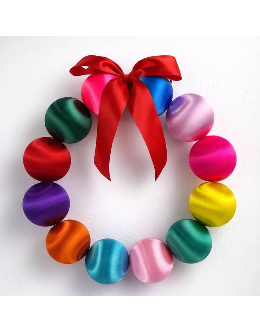 Colorful Little Fish Co silk ball Christmas wreath with vibrant multi-colored silk balls and green foliage for holiday decor.