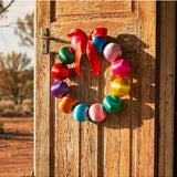 Colorful Little Fish Co silk ball Christmas wreath with vibrant multi-colored silk balls, perfect for festive holiday decor.