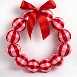 Little Fish Co silk ball Christmas wreath in red and pink with decorative silk balls and festive holiday accents.