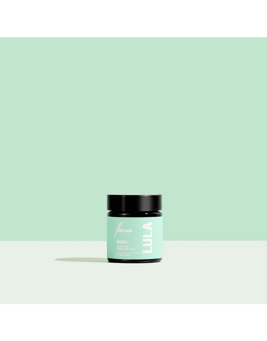 Lula Focus Balm essential oil in a small glass jar with natural ingredients, designed for aromatherapy and mental clarity.