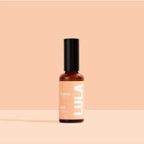 Lula Happy Mist essential oil bottle with a colorful label, showcasing a natural, calming aromatherapy product from Lula.