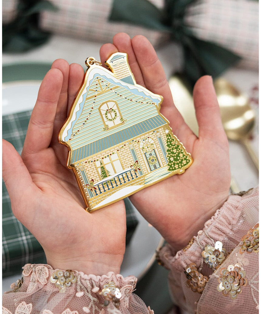 Bespoke Letterpress fine enamel Christmas house ornament hanging on a festive tree branch.