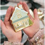 Bespoke Letterpress fine enamel Christmas house ornament hanging on a festive tree branch.