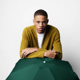 Green Anatole Gustave micro-umbrella open showing compact size and lightweight design, perfect for travel and everyday use.