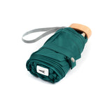 Green Anatole Gustave micro-umbrella featuring a compact design and sturdy handle, ideal for rain protection.