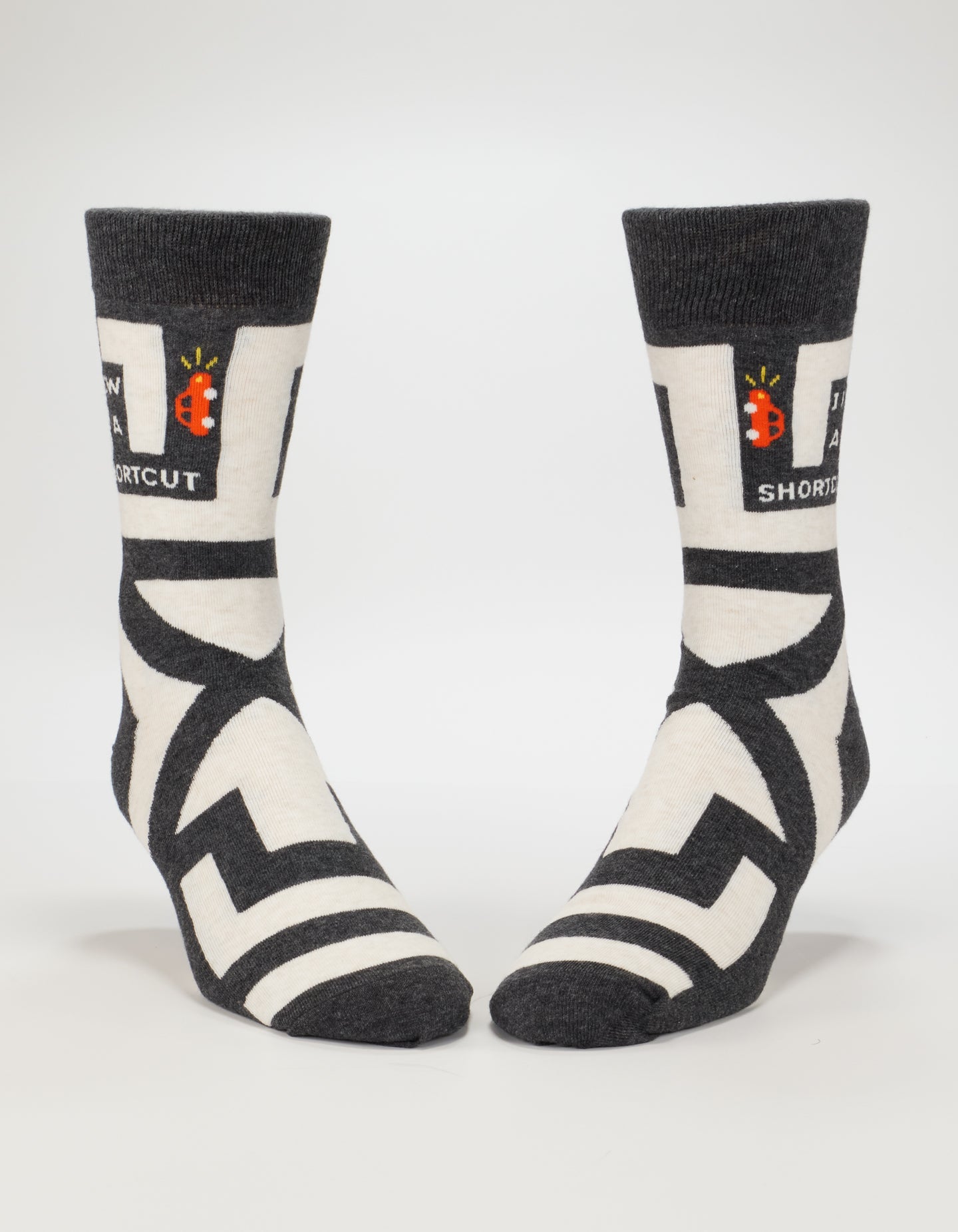 Blue Q men's crew socks featuring the "I Know A Shortcut" design with colorful patterns on soft fabric.