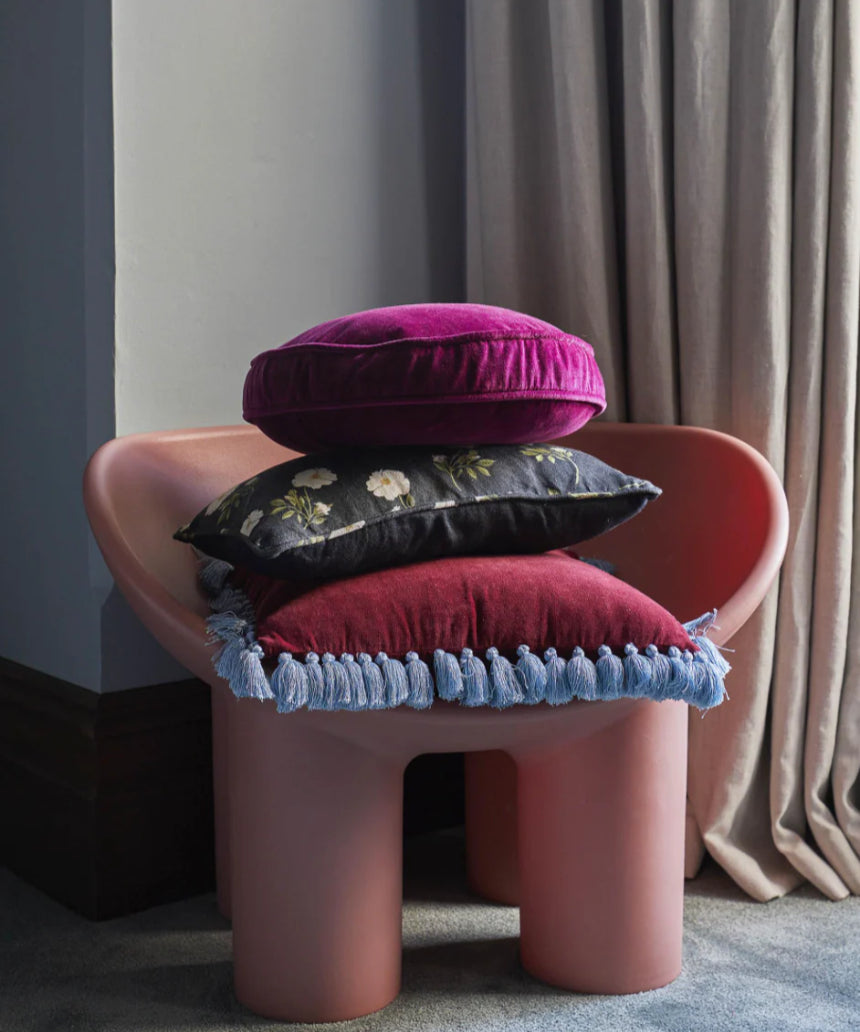 Kip & Co Anemone Velvet Pea Cushion with floral pattern, soft velvet fabric, decorative home accent on a sofa or bed.