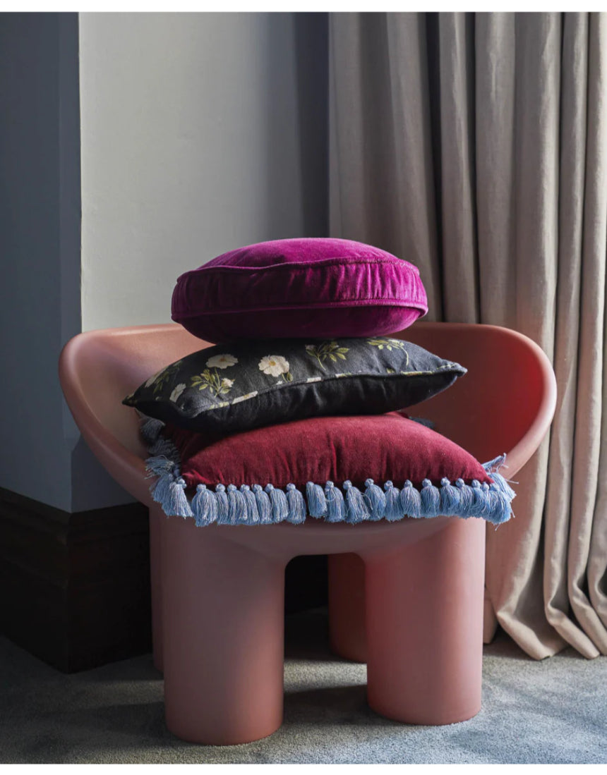 Kip & Co Anemone Velvet Pea Cushion with floral pattern, soft velvet fabric, decorative home accent on a sofa or bed.