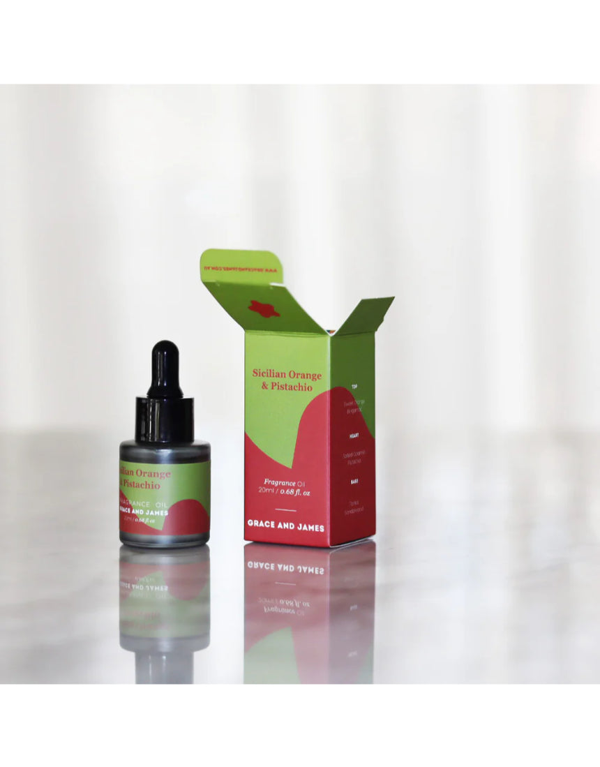 Orange and pistachio felt air freshener refill by Grace & James, featuring a vibrant citrus and nut-scented design.