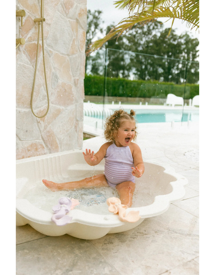 Winnie Parkes Maeve the Mermaid rubber teether in peach, featuring a playful mermaid design for infants.