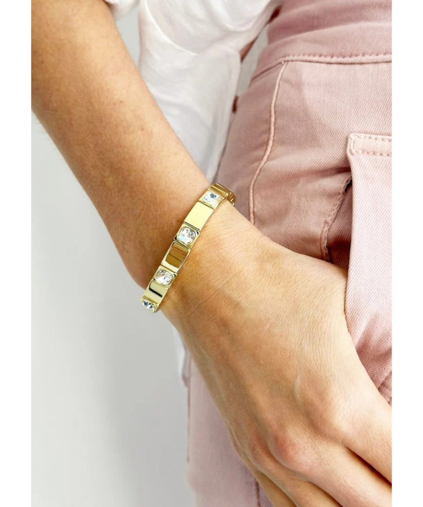 Gold Queenie bracelet by Mosk Melbourne featuring a sleek, elegant design with blue gemstone accents.
