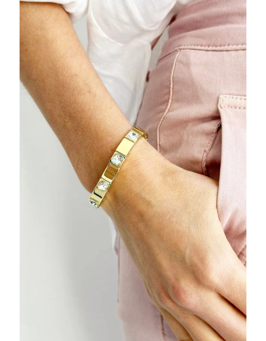 Gold Queenie bracelet by Mosk Melbourne featuring a sleek, elegant design with blue gemstone accents.