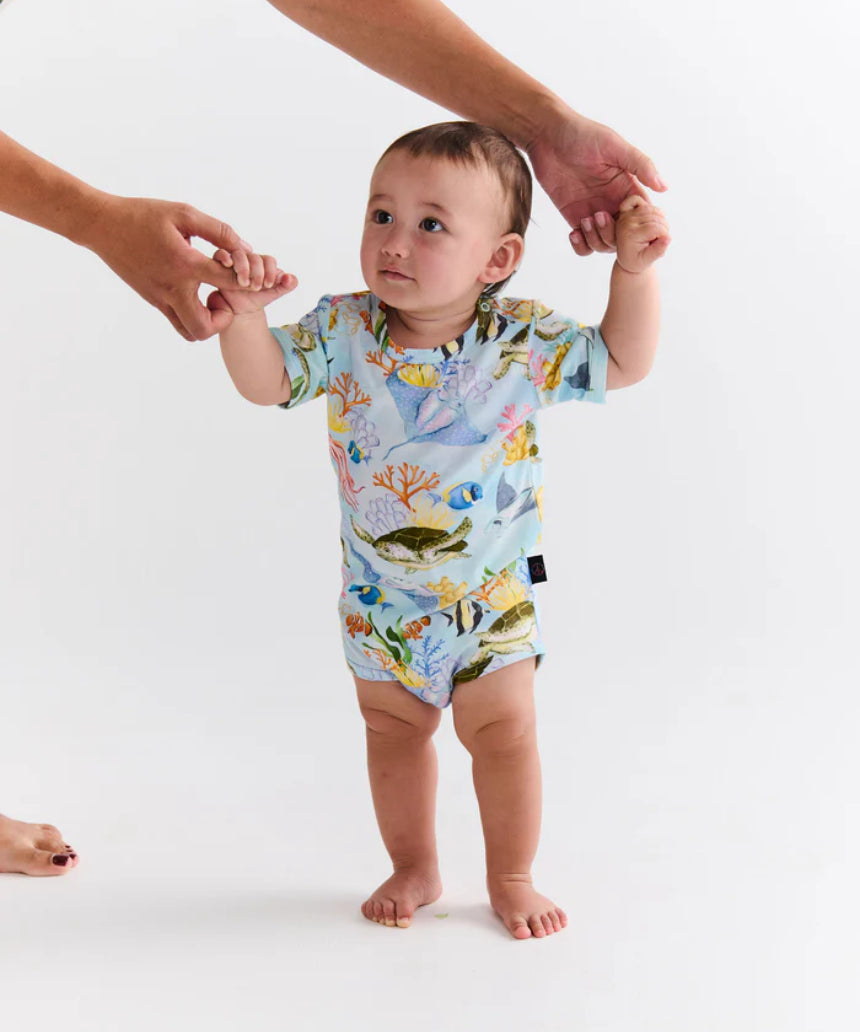Kip & Co Reef Life short sleeve baby romper with colorful reef and ocean print, lightweight and comfortable for infants.