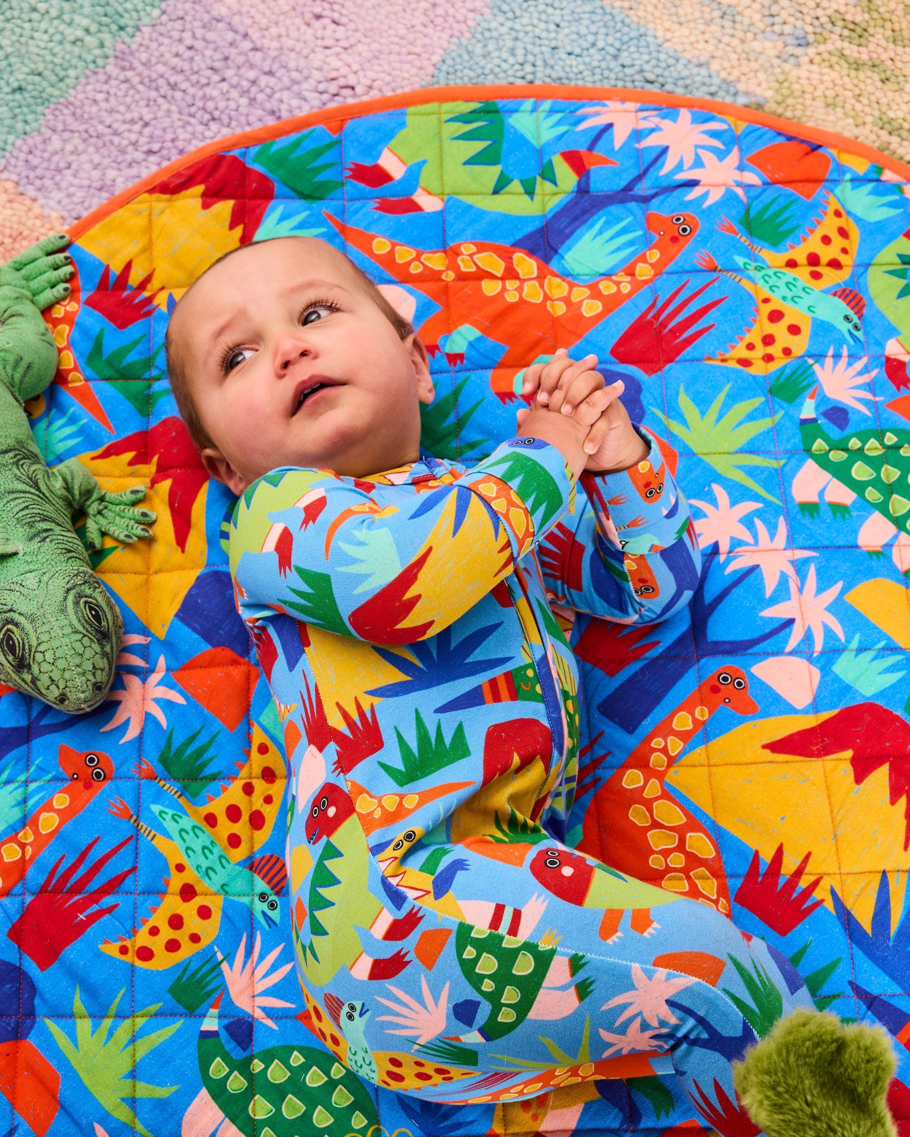 Kip & Co Dinosaur Roar organic long sleeve zip romper for babies, featuring colorful dinosaur print and soft cotton fabric.