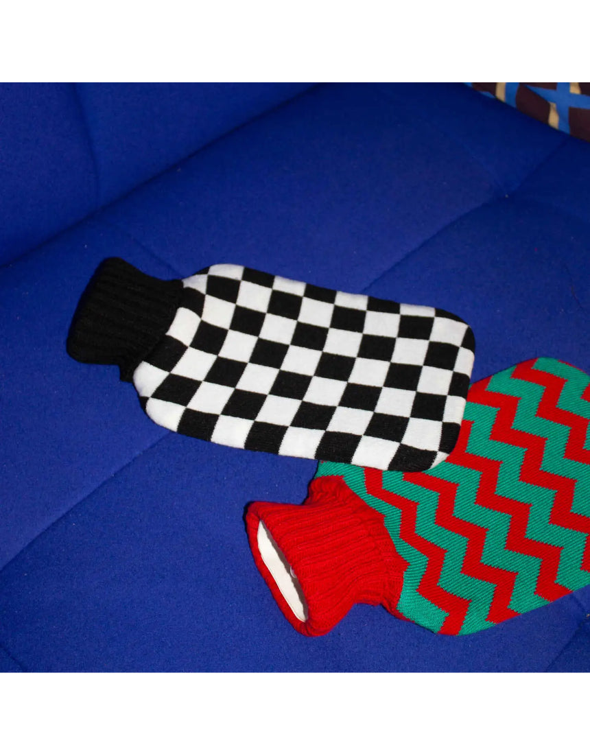 Casa Rolio hot water bottle with black cover, soft texture, and rounded shape for warmth and comfort.