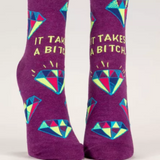 Blue Q ankle socks featuring humorous "It Takes A Bitch" design, casual socks for everyday wear.