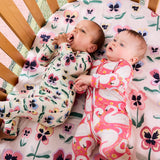 Kip & Co Pretty Pansy organic long sleeve zip romper for babies, featuring colorful floral print and soft cotton fabric.