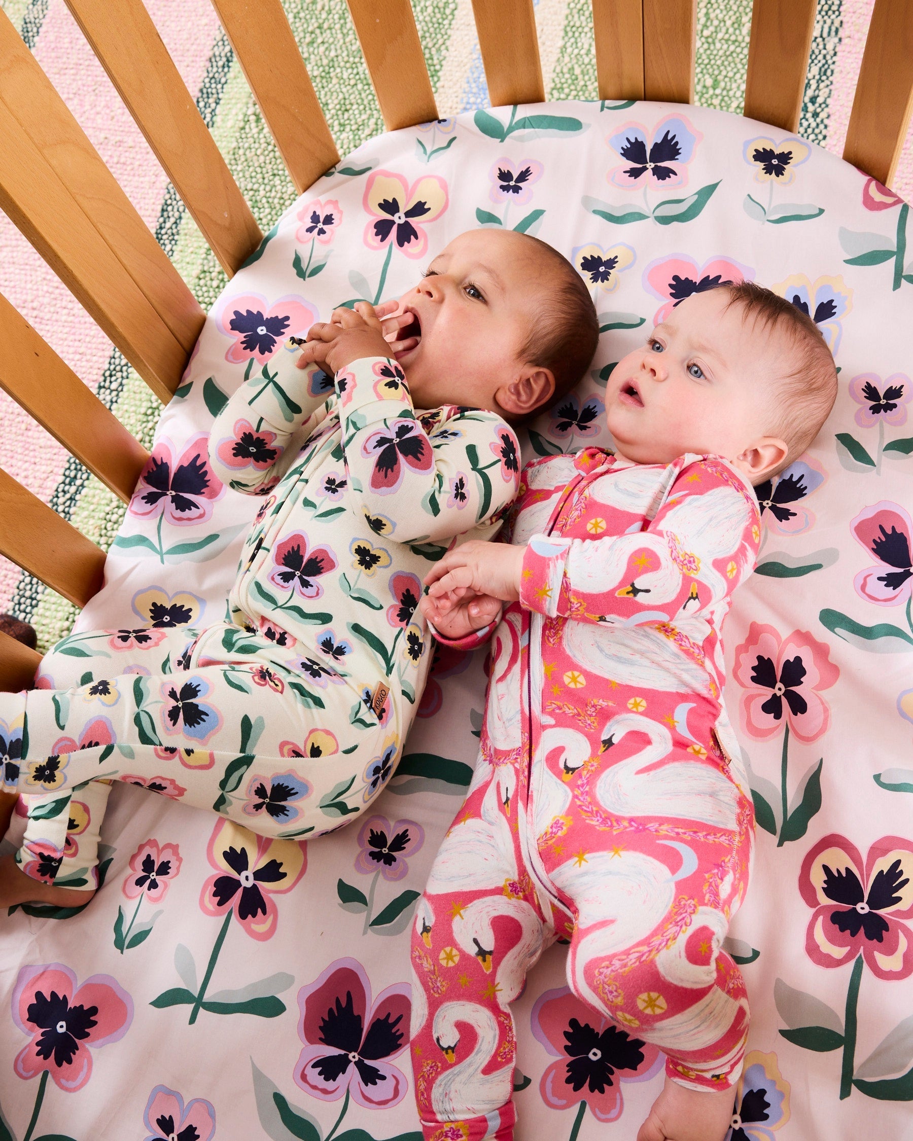 Kip & Co Pretty Pansy organic long sleeve zip romper for babies, featuring colorful floral print and soft cotton fabric.