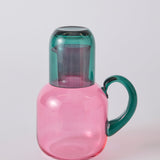 Kip & Co Isle of Pink glass carafe and matching glass set with pink and white design on clear glass.
