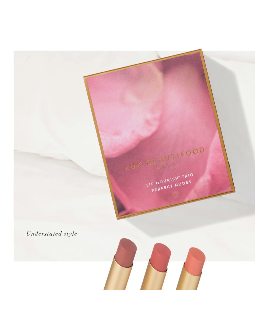 Lük Beautifood Lip Nourish Trio featuring three natural nude lip balms with sleek packaging on a white background.