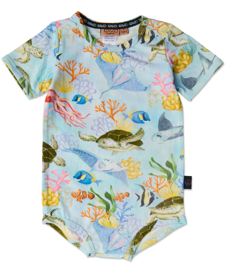 Baby wearing Kip & Co Reef Life short sleeve romper with colorful tropical print, short sleeves, and comfortable fit.