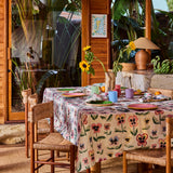 Kip & Co Pretty Pansy tablecloth with colorful floral design, draped over a dining table for a vibrant, stylish look.