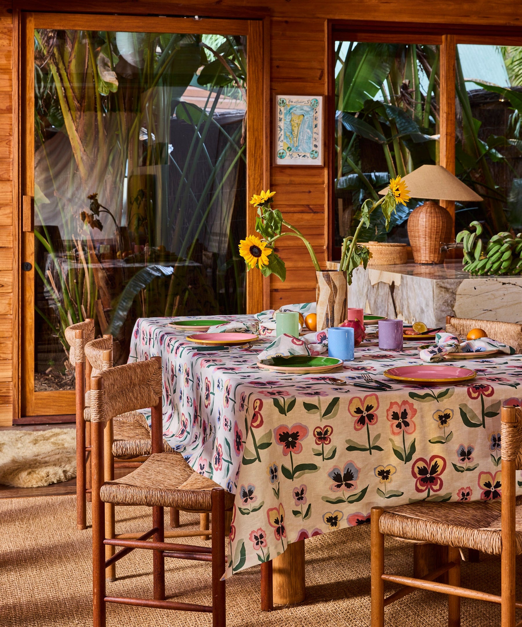 Kip & Co Pretty Pansy tablecloth with colorful floral design, draped over a dining table for a vibrant, stylish look.