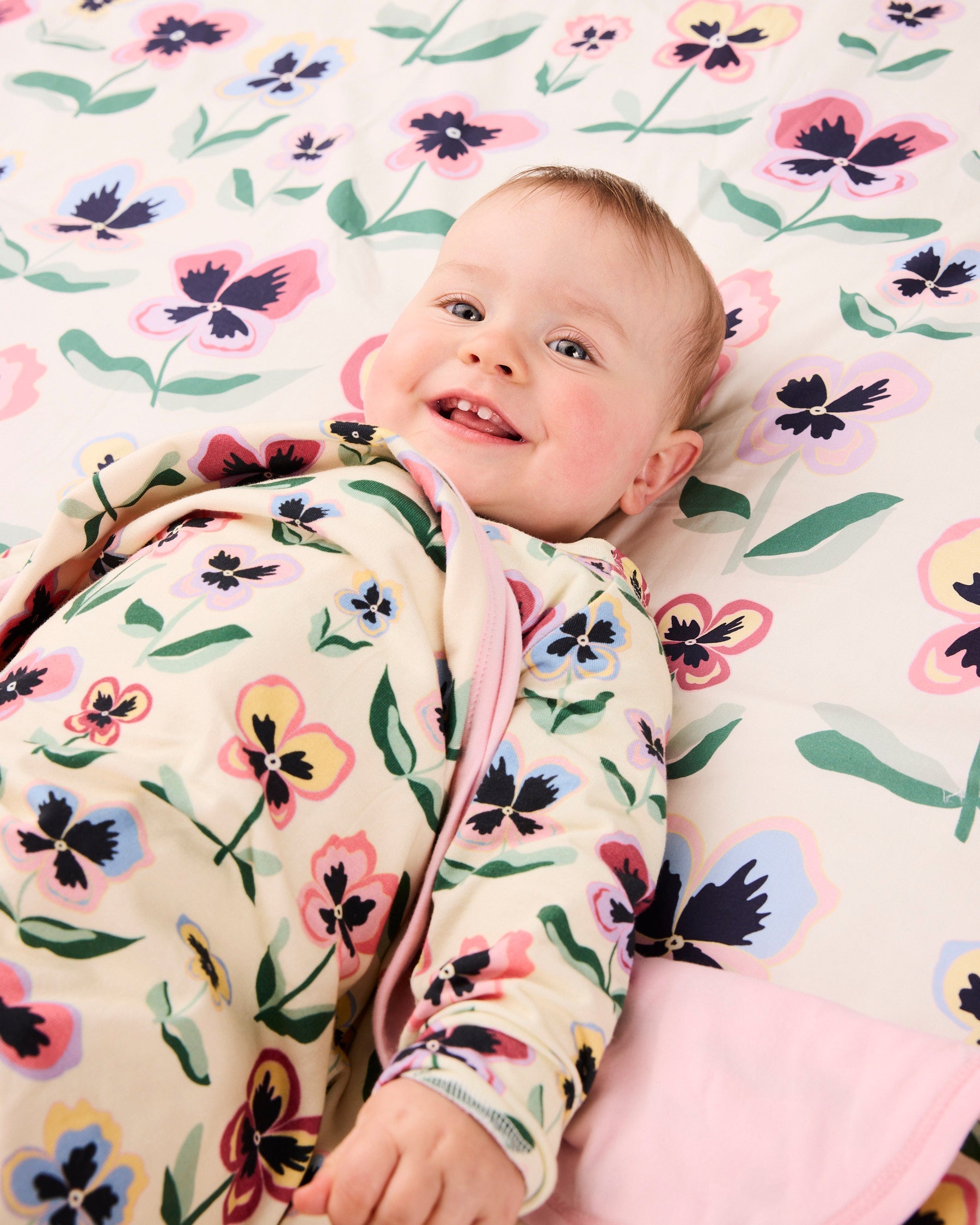 Kip & Co Pretty Pansy organic cotton baby blanket with colorful floral pattern and soft texture.