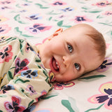 Kip & Co Pretty Pansy organic long sleeve zip romper for babies, featuring floral print and soft cotton fabric.