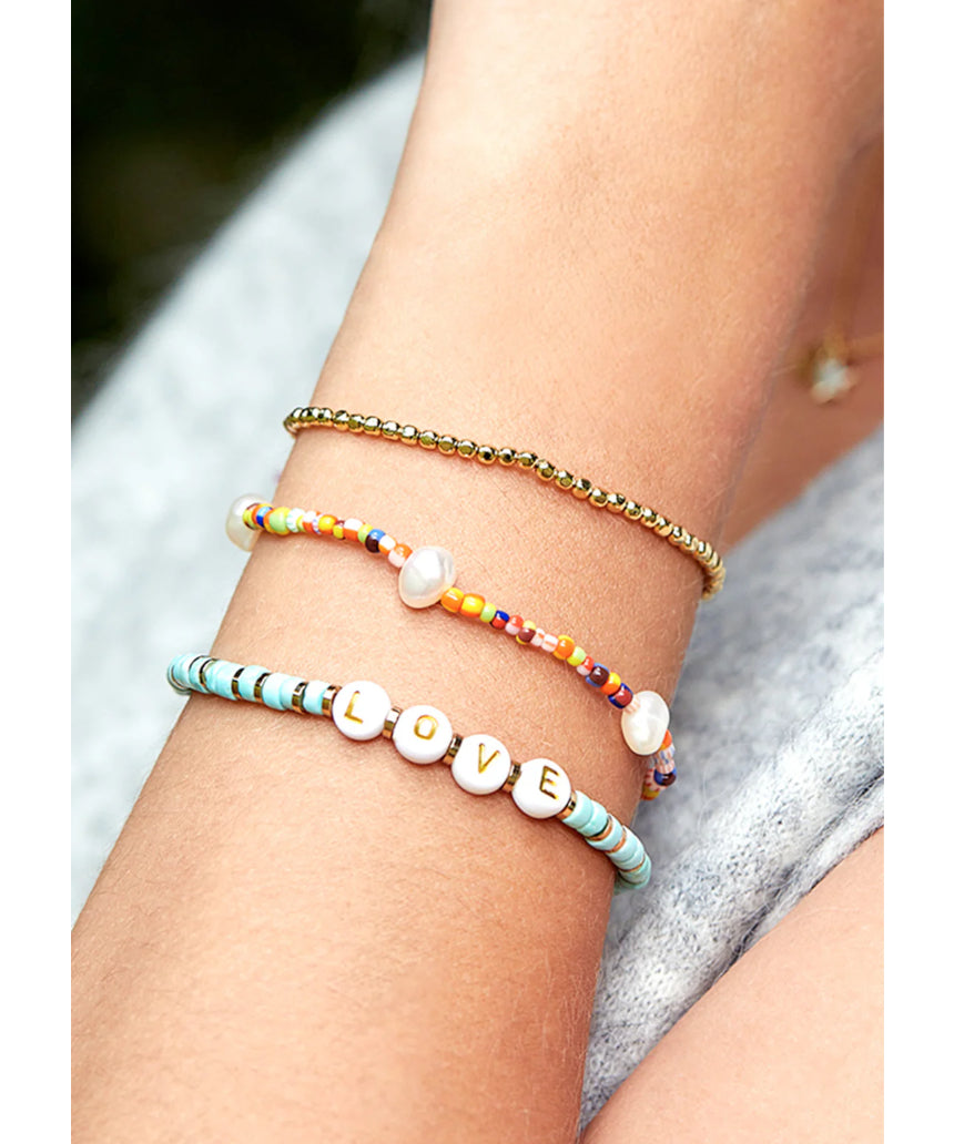 Estella Bartlett rainbow pearl bracelet set featuring colorful pearl designs on delicate bracelets for a stylish accessory.