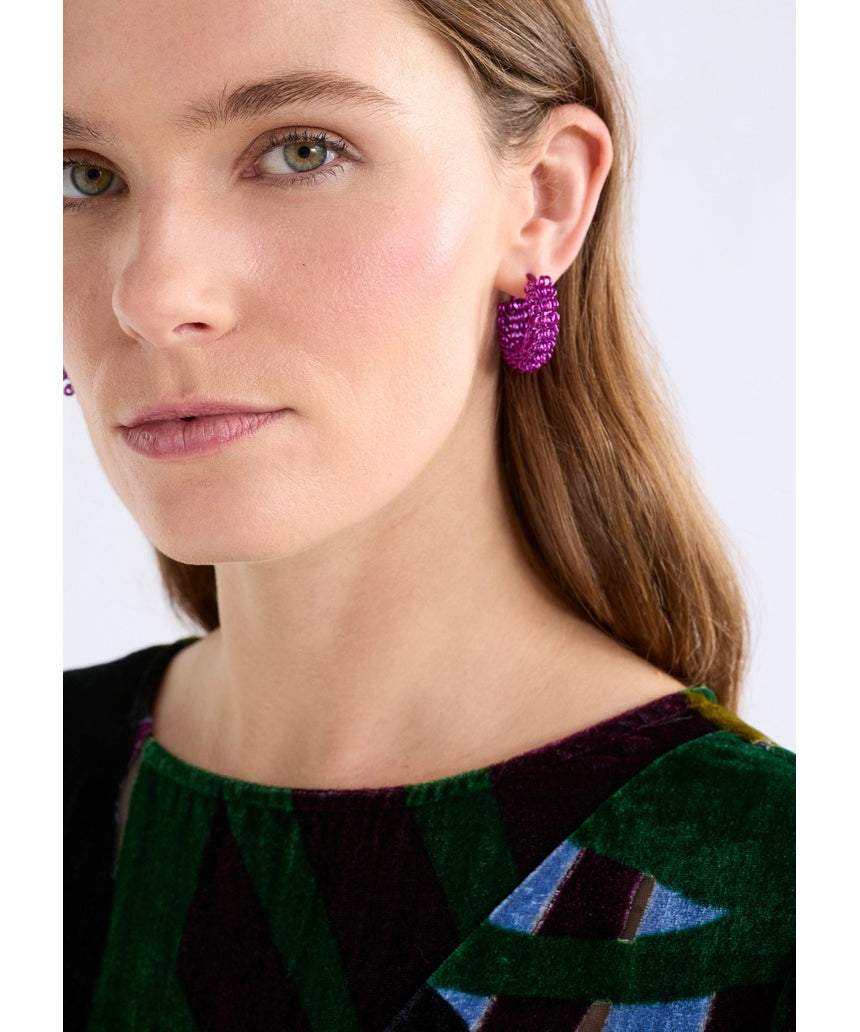 Fuchsia ELK The Label Klippan hoop earring with a bold, circular design, made of lightweight metal, on a neutral background.