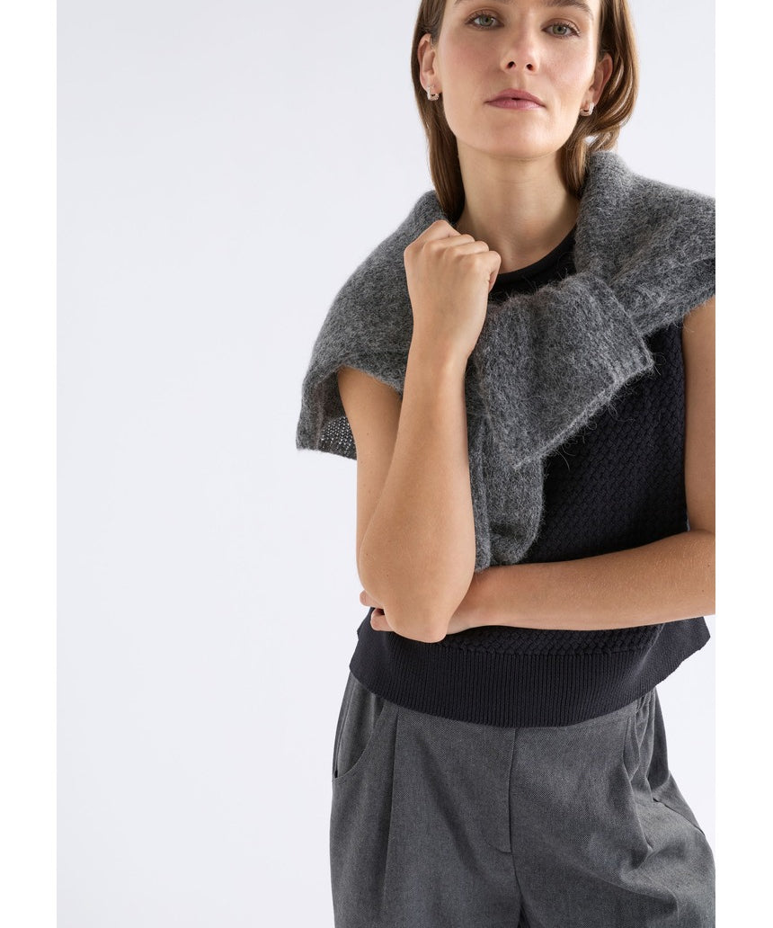 Black Elk Naya Knit Vest from ELK The Label, featuring a cozy knitwear design with a high neckline and textured pattern.