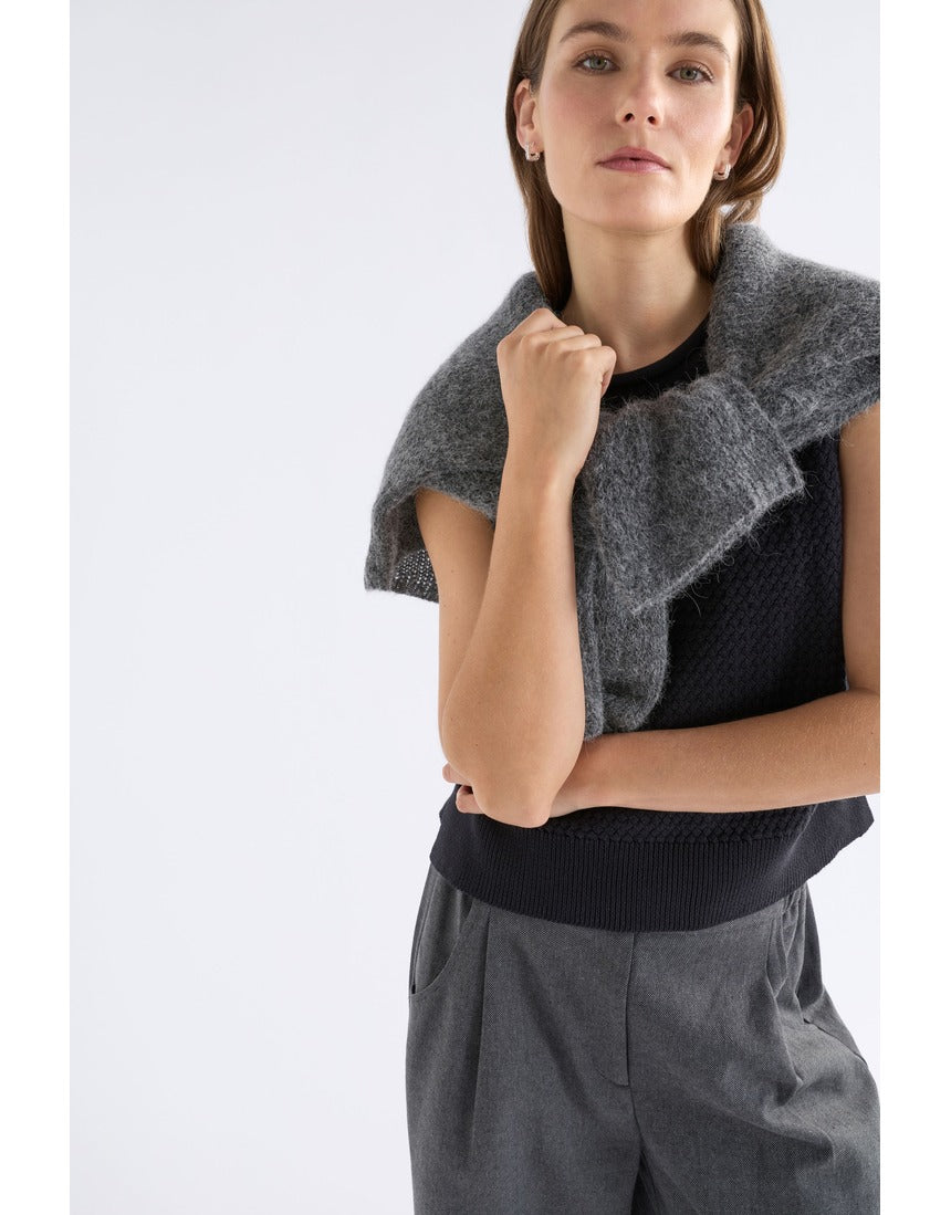 Black Elk Naya Knit Vest from ELK The Label, featuring a cozy knitwear design with a high neckline and textured pattern.