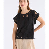 Black Varr Burnout Top by ELK The Label featuring a relaxed fit and burnout fabric, shown on a model.