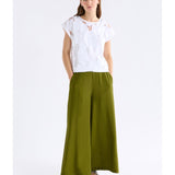White Varr Burnout Top by ELK The Label, featuring lightweight fabric and relaxed fit, shown hanging on a hanger.