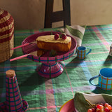 Kip & Co Soiree Diner Knife and Slide Set featuring sleek stainless steel utensils with colorful handles on a dining table.
