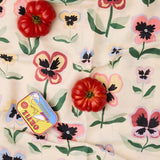 Kip & Co Pretty Pansy tablecloth with vibrant floral pattern on fabric, perfect for adding color to dining tables.