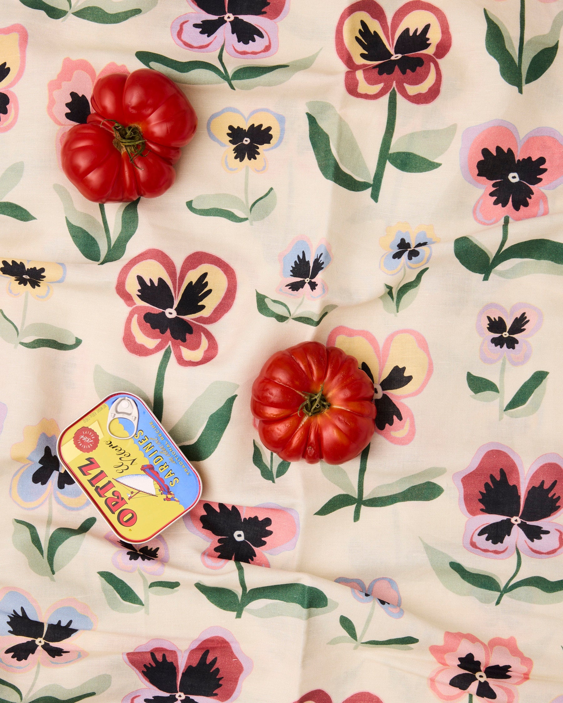 Kip & Co Pretty Pansy tablecloth with vibrant floral pattern on fabric, perfect for adding color to dining tables.