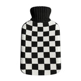 Casa Rolio hot water bottle with black cover, soft fabric exterior and rounded shape, ideal for warmth and comfort.