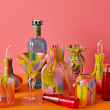 Kip & Co Festiva glass and carafe set with colorful floral pattern on clear glass, showcasing stylish drinkware.