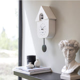 White Fisura Cuckoo Clock with traditional design and wooden details, featuring a small cuckoo bird on the front.