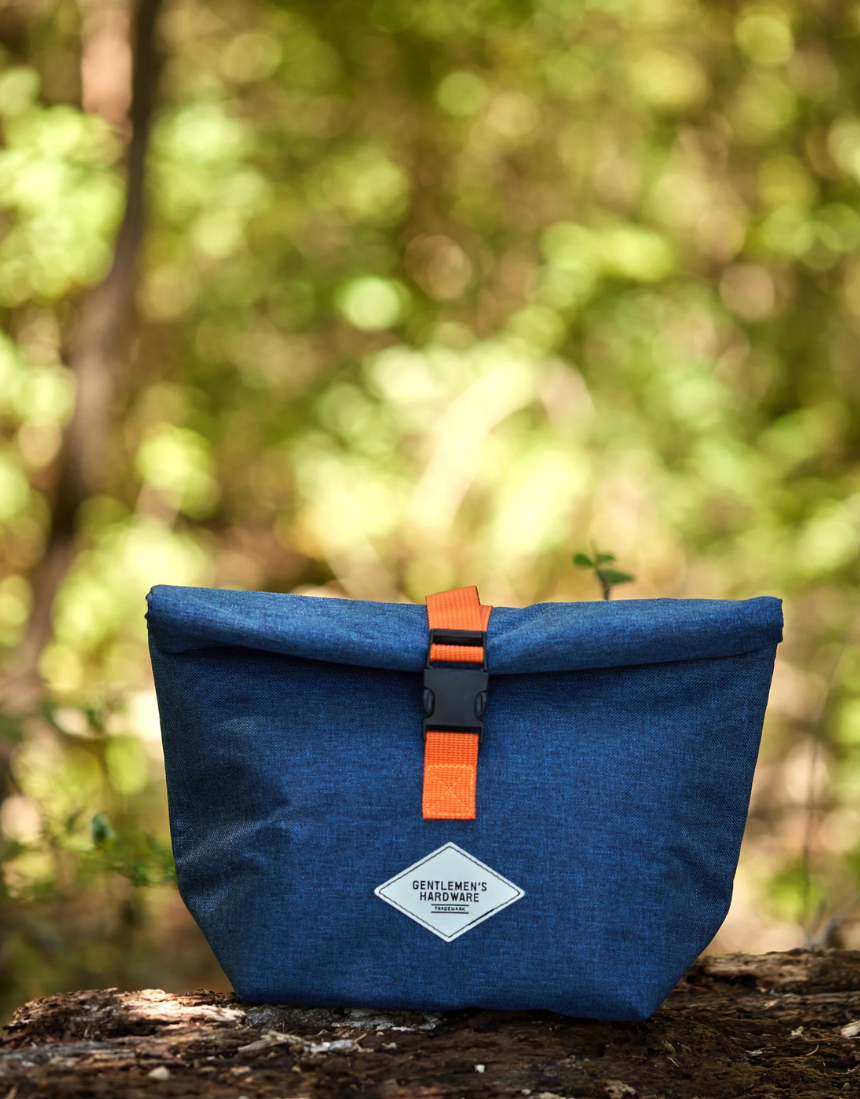 Gentlemen's Hardware roll-top lunch bag with durable fabric and adjustable strap, suitable for carrying lunch on the go.
