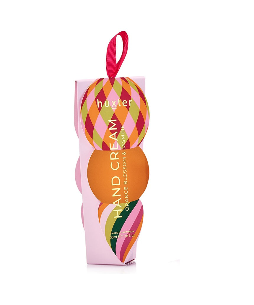 Huxter Adorned Christmas Hanging Hand Cream in soft pink with festive decorative wrapping and hanging ribbon.