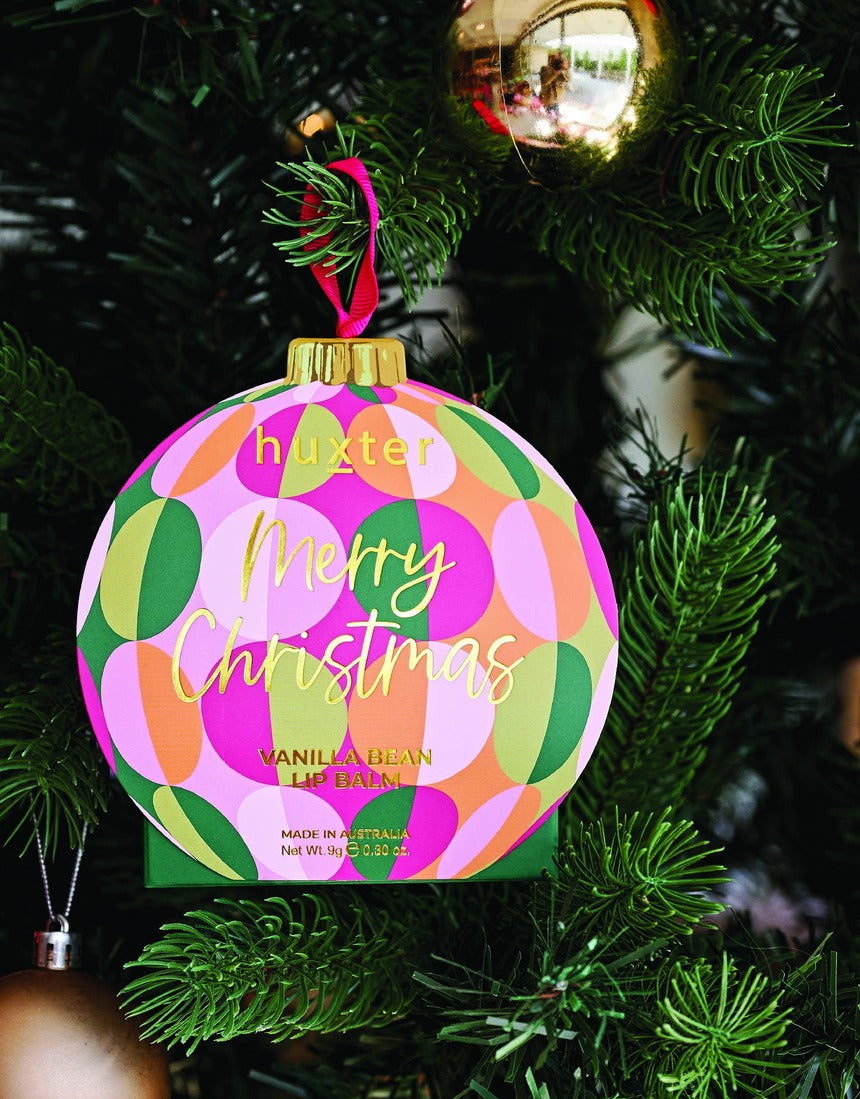 Huxter Green Hanging Lip Balm displayed on a Christmas tree