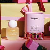 Huxter Christmas Nourishing Dry Oil styled with colourful gifts