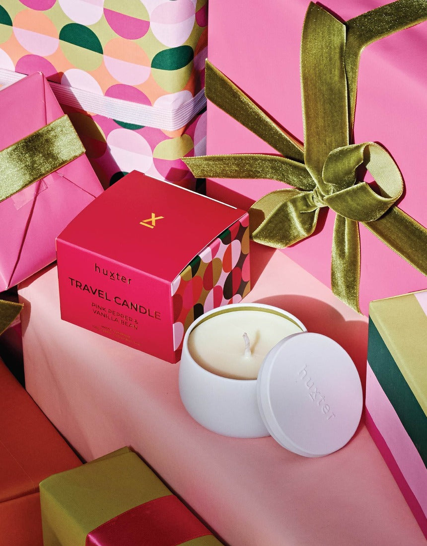 Huxter Adorned Christmas Travel Candle with pink pepper and vanilla bean scent, showcasing a festive holiday-themed candle design.