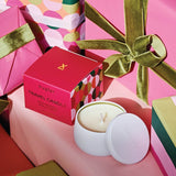 Huxter Adorned Christmas Travel Candle with pink pepper and vanilla bean scent, showcasing a festive holiday-themed candle design.